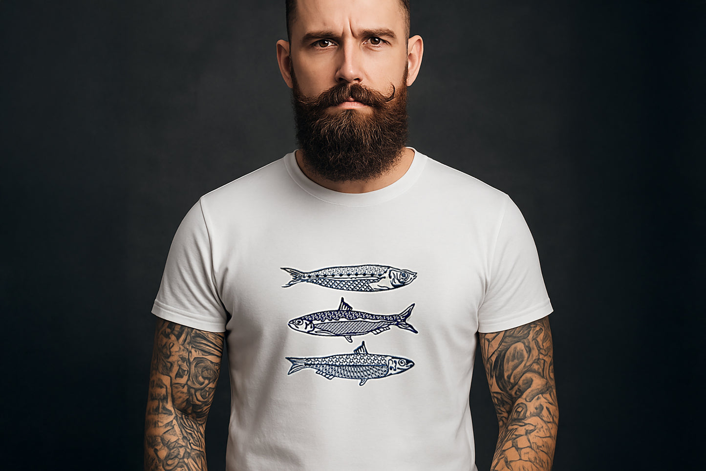 Man wearing a white t-shirt with fish designs on a dark background