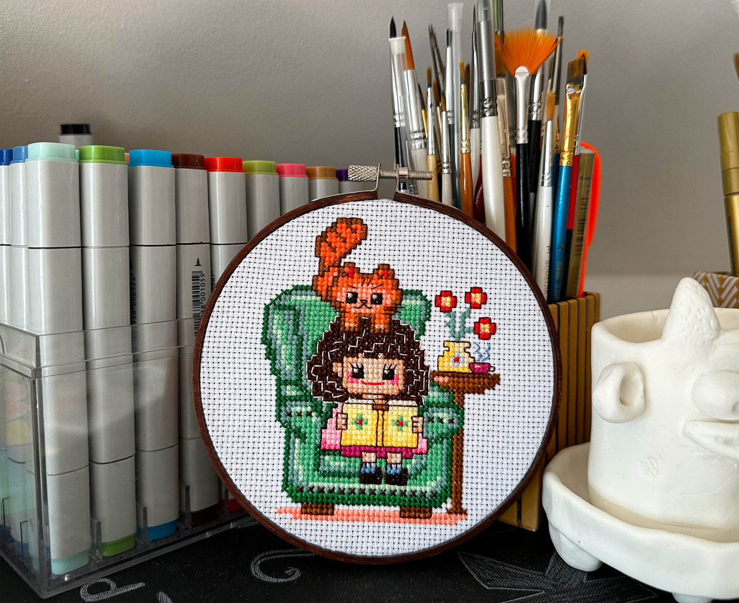 Cute girl in chair with book PDF cross stitch pattern