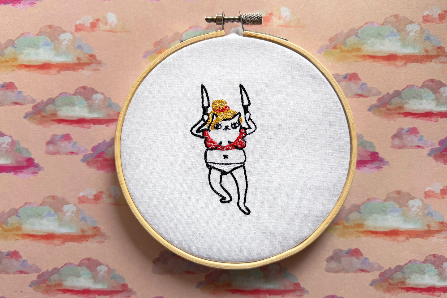 Humorous cat embroidery referencing viral Britney Spears knife video