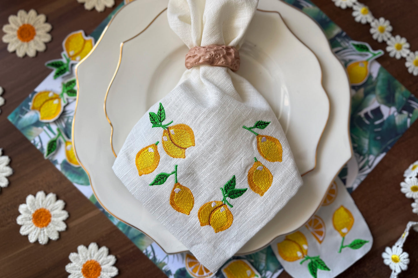 Machine embroidery of a whole lemon on white fabric