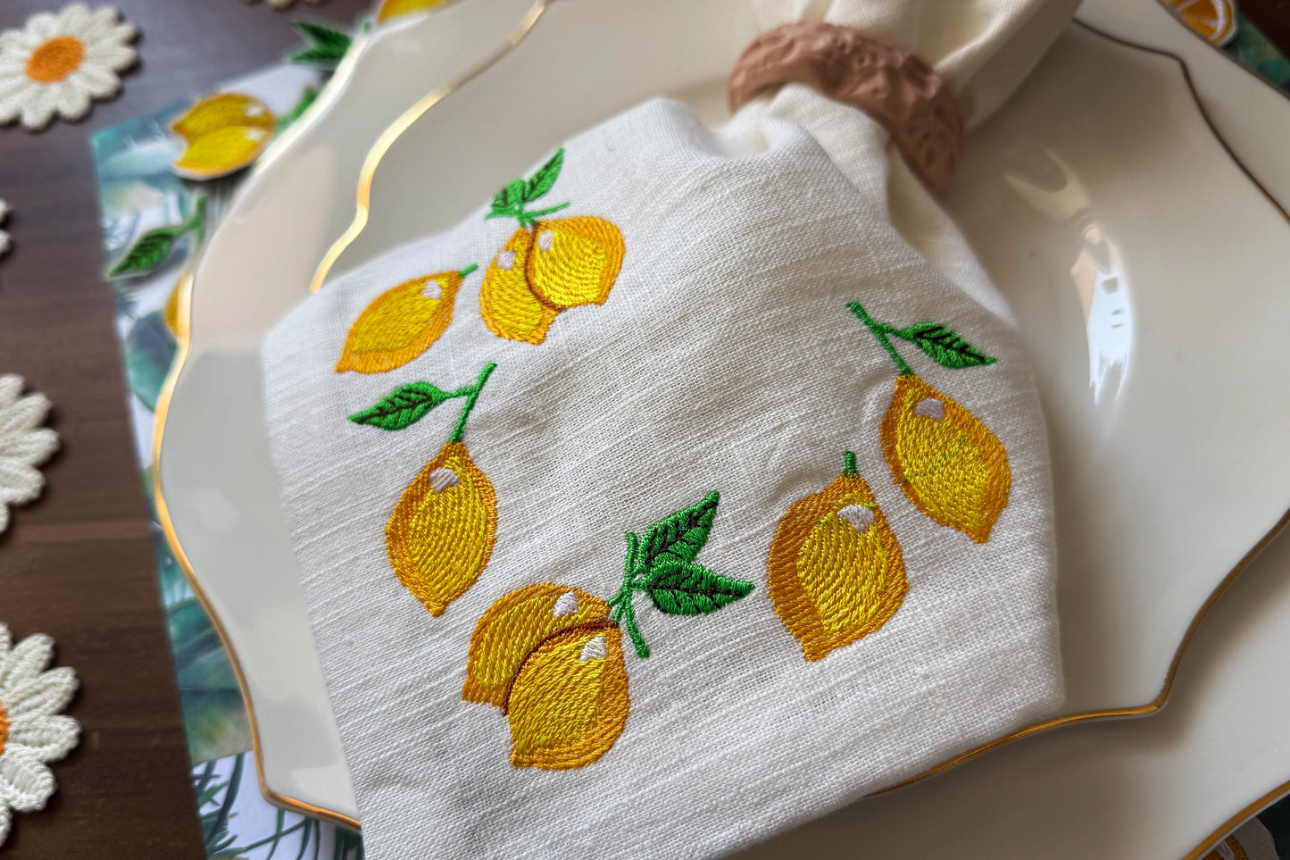 Lemon with green leaf machine embroidery on white background