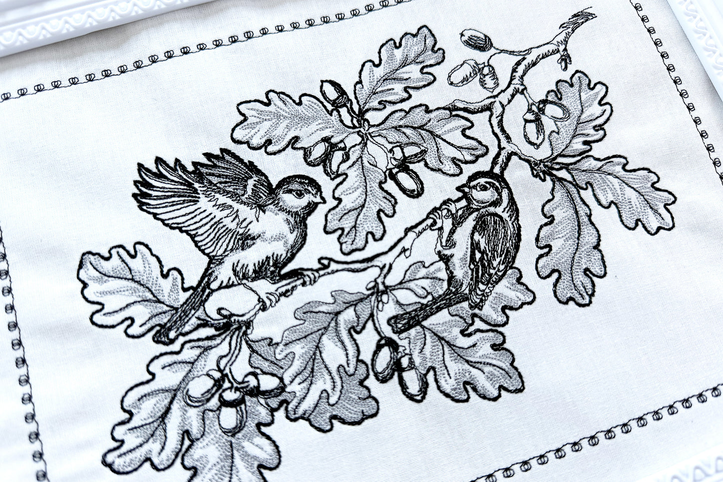 Elegant machine embroidery design featuring two birds on an oak branch with acorns. A rare OOAK pattern using just two thread colors, perfect for timeless décor, unique gifts, and Thanksgiving embroidery projects.