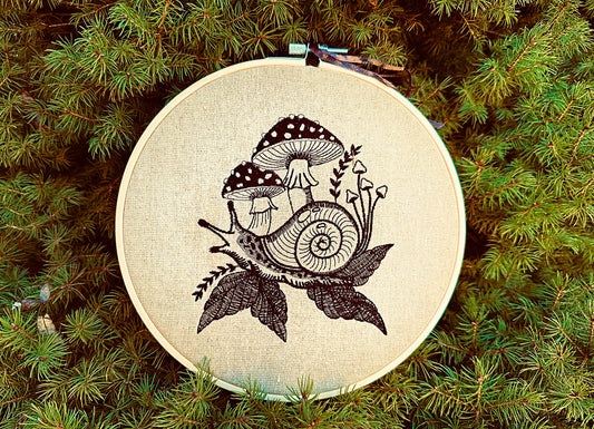 Blackwork snail embroidery with mushrooms and leaves on natural fabric