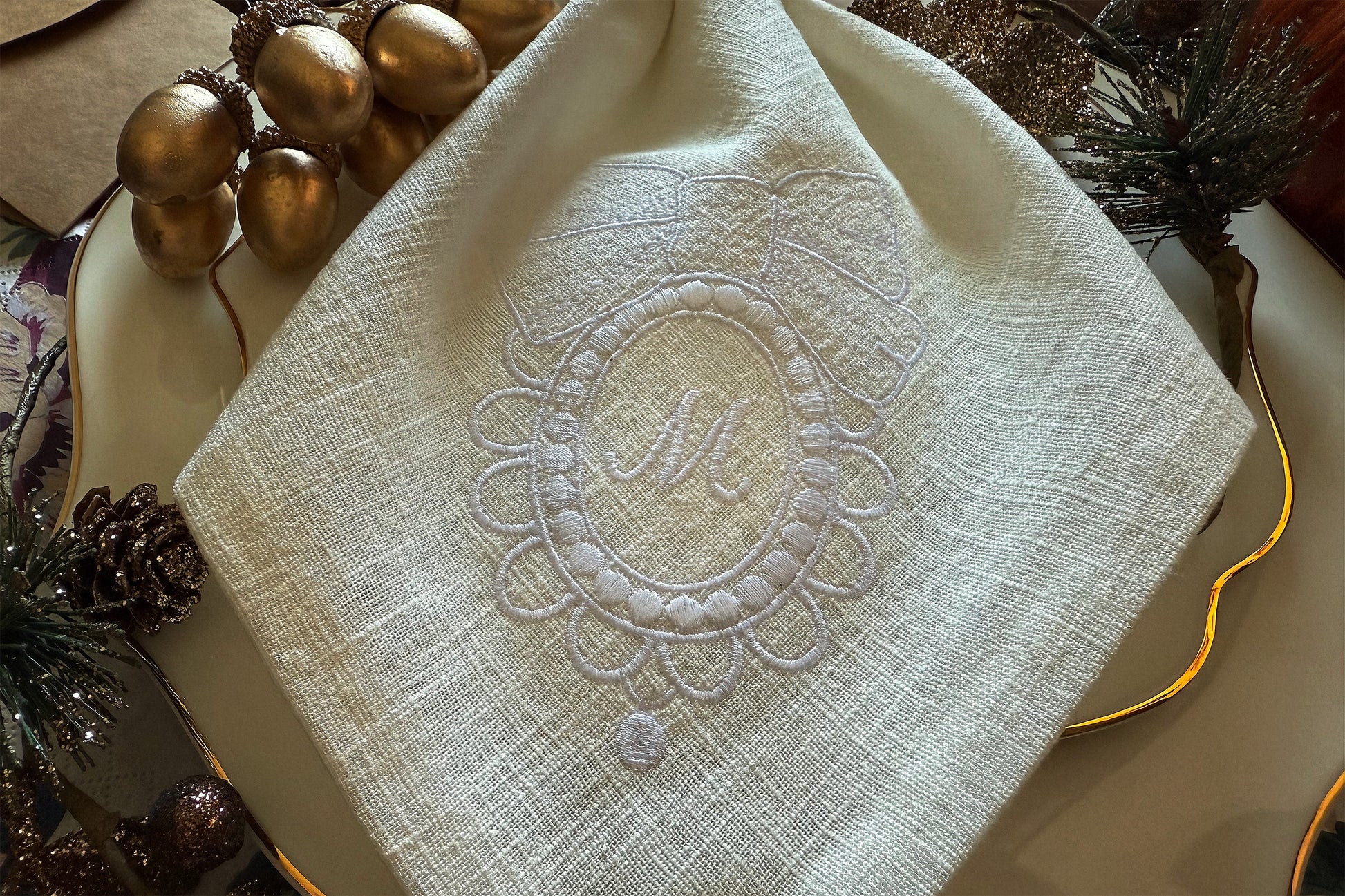 Elegant bow frame embroidery design for napkins – stitched sample in hoop