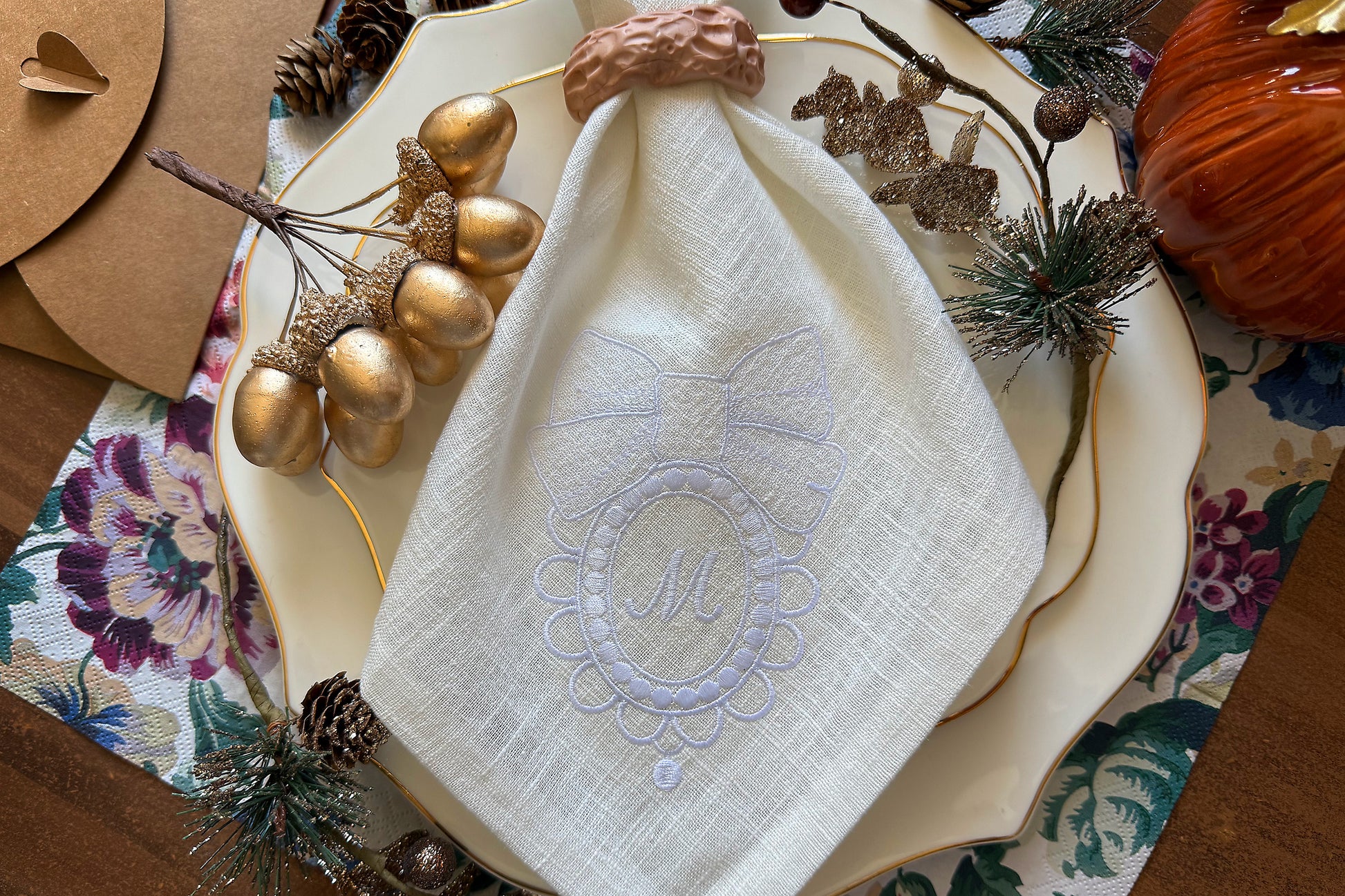 Elegant bow frame embroidery design for napkins – stitched sample in hoop