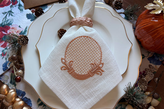 Decorative retro-style embroidery frame stitched on white linen napkin.