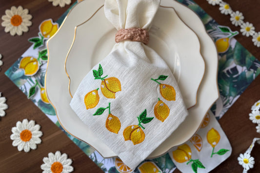 Machine embroidery of a whole lemon on white fabric