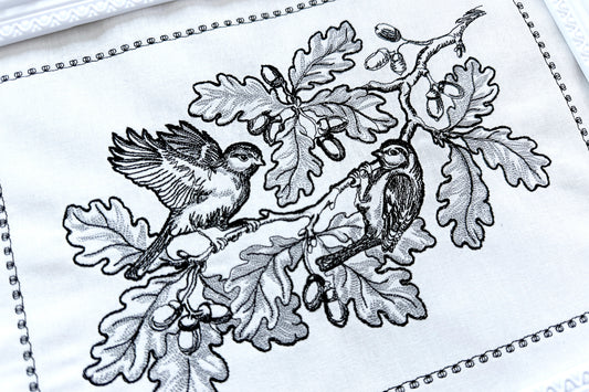 Elegant machine embroidery design featuring two birds on an oak branch with acorns. A rare OOAK pattern using just two thread colors, perfect for timeless décor, unique gifts, and Thanksgiving embroidery projects.