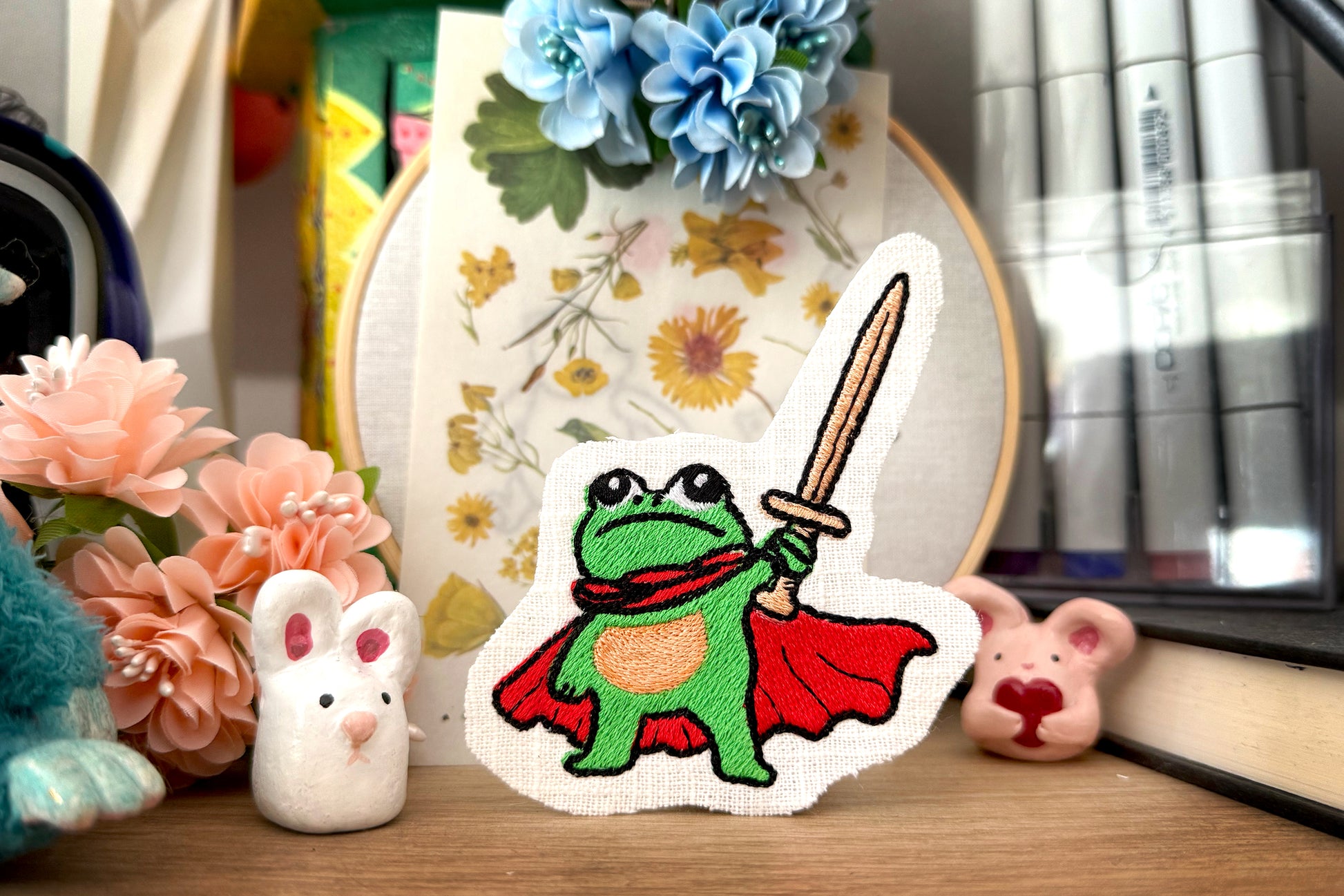 Heroic frog embroidery design holding a sword