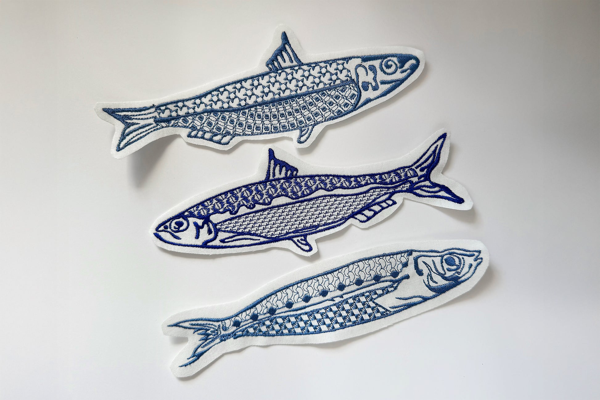 3. Unique sardine machine embroidery on white fabric background