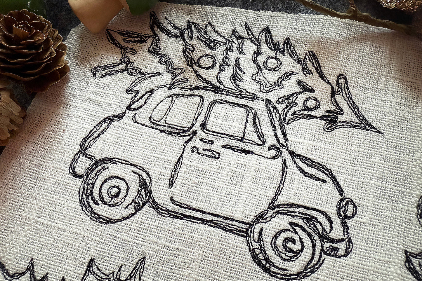 Embroidery design of a car with flames on a fabric background
