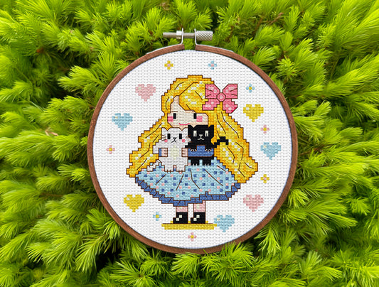 Cross stitch design of a blonde girl with two cats, black and white, in a pixel style.