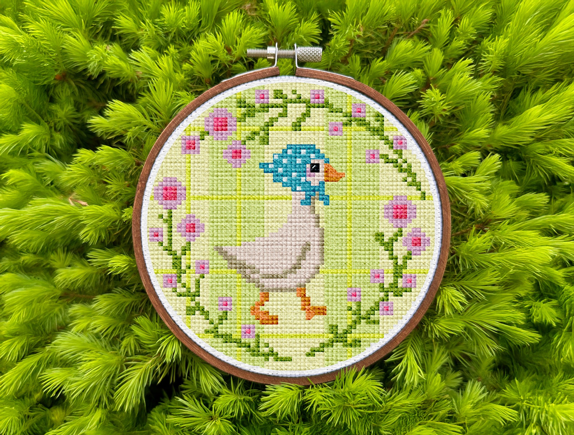 Pastel cross-stitch art of goose on striped background for cozy decor