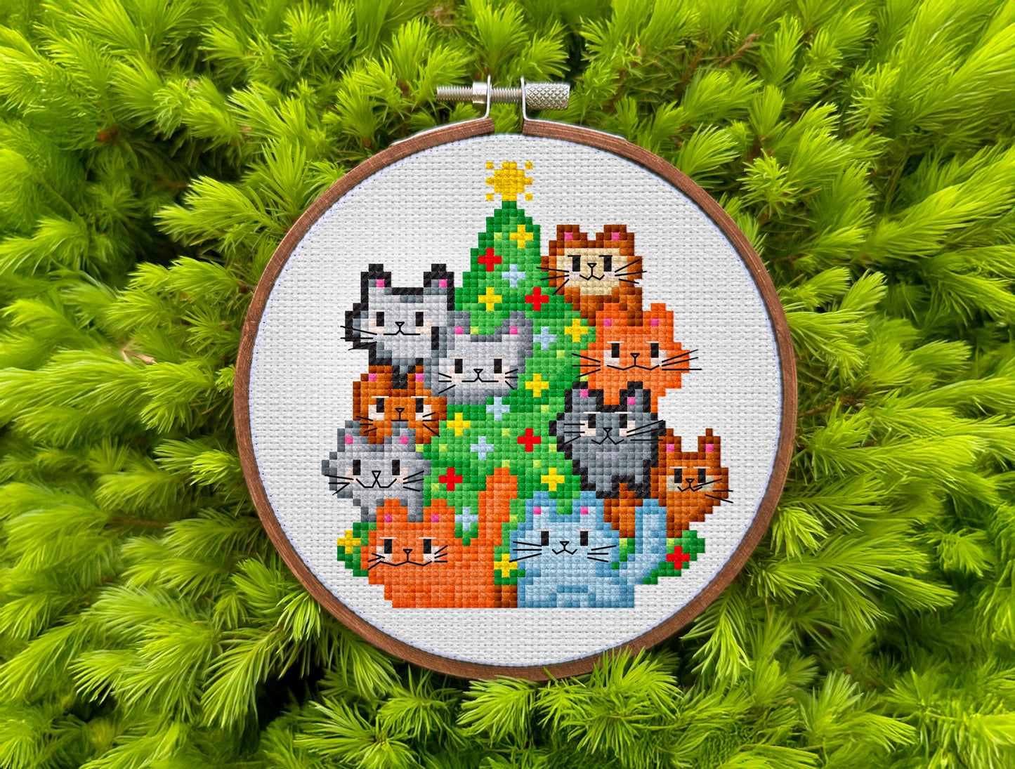 Playful festive cross-stitch pattern featuring colorful cats and ornaments