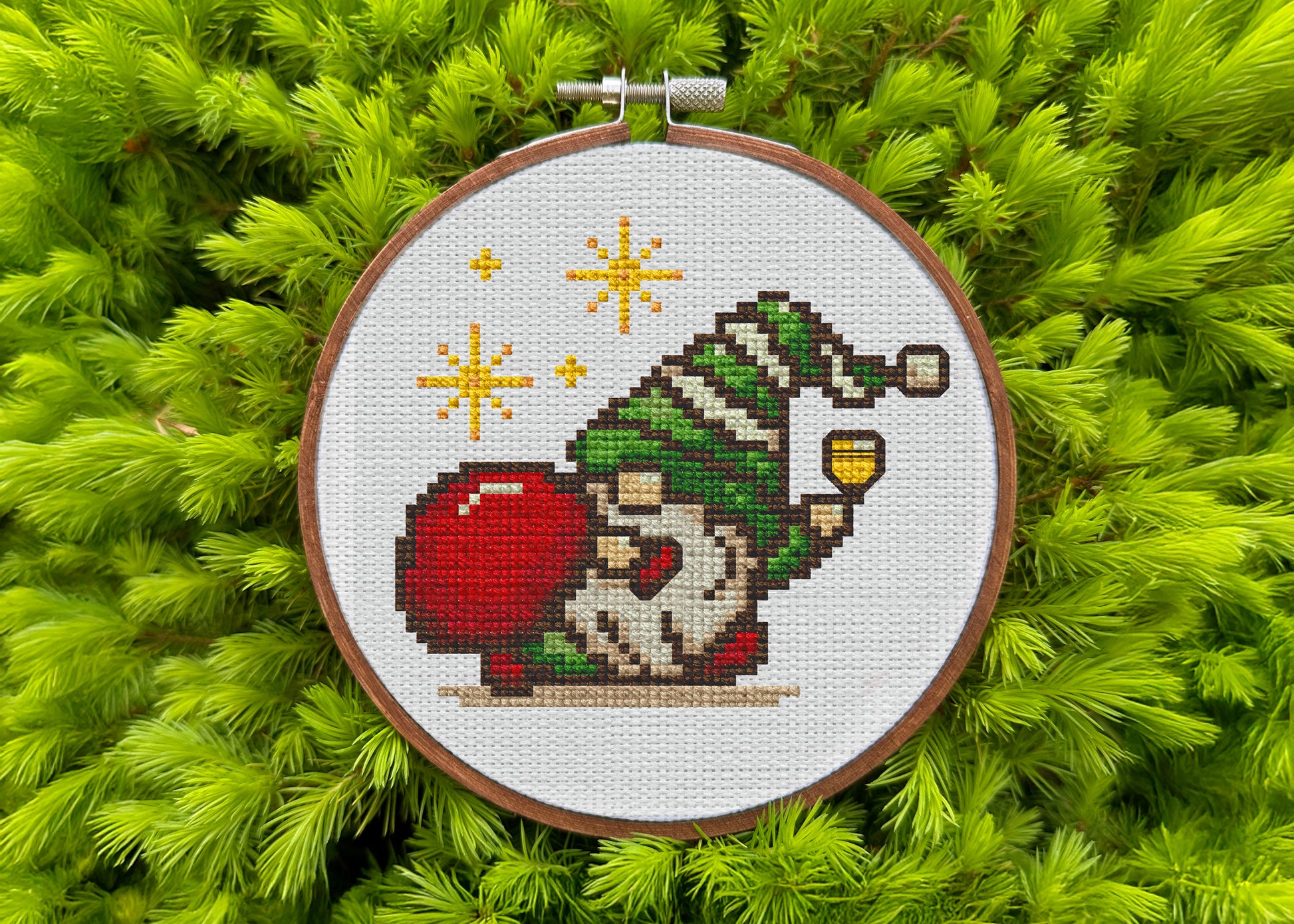 Cross-stitched gnome ornament on a green textured background