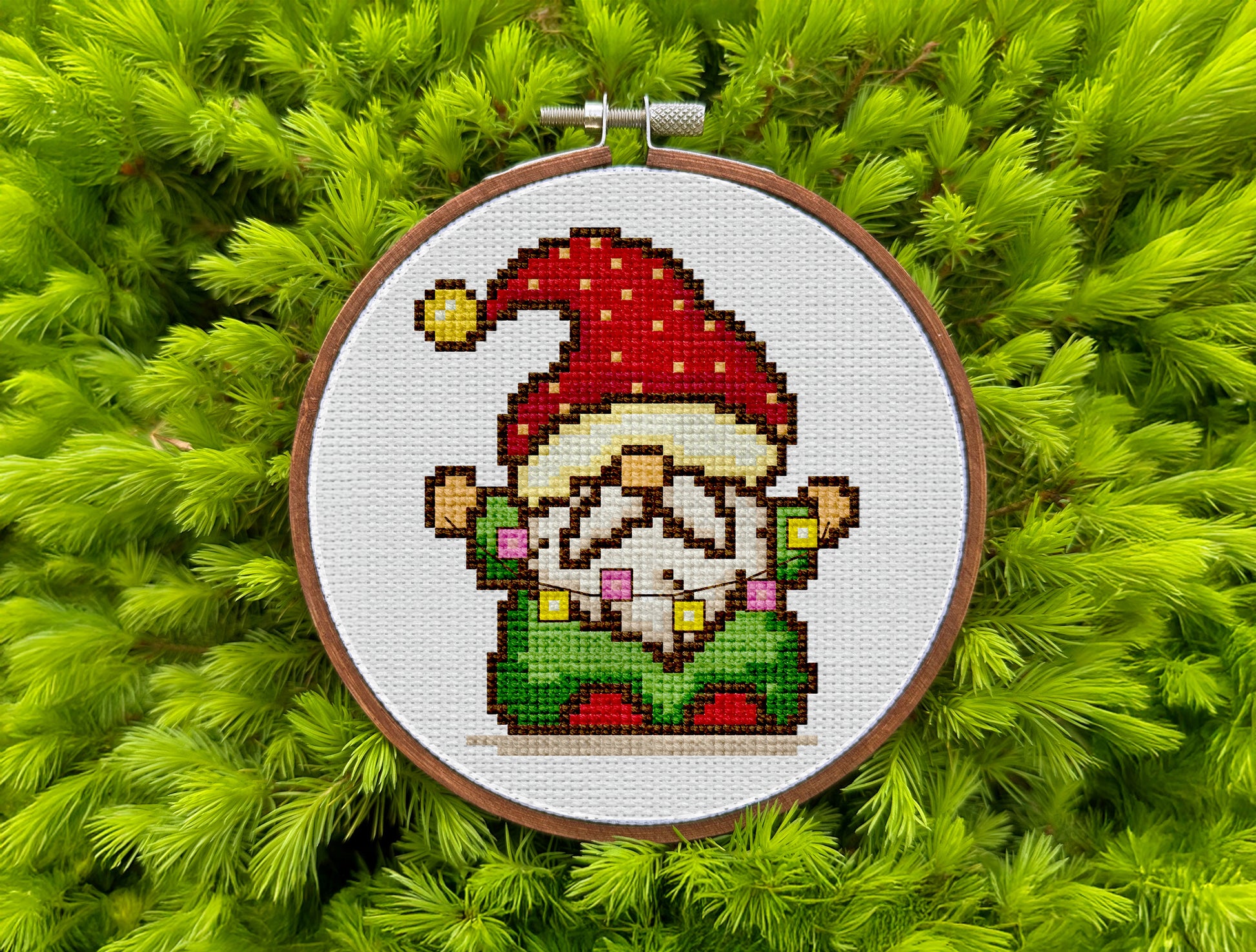 Festive embroidery design with Christmas gnome and lights