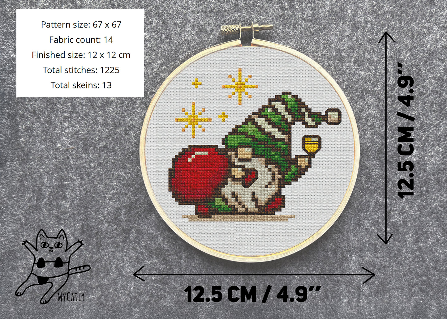 Cross-stitched gnome pattern in a hoop with dimensions and fabric details on a gray background.