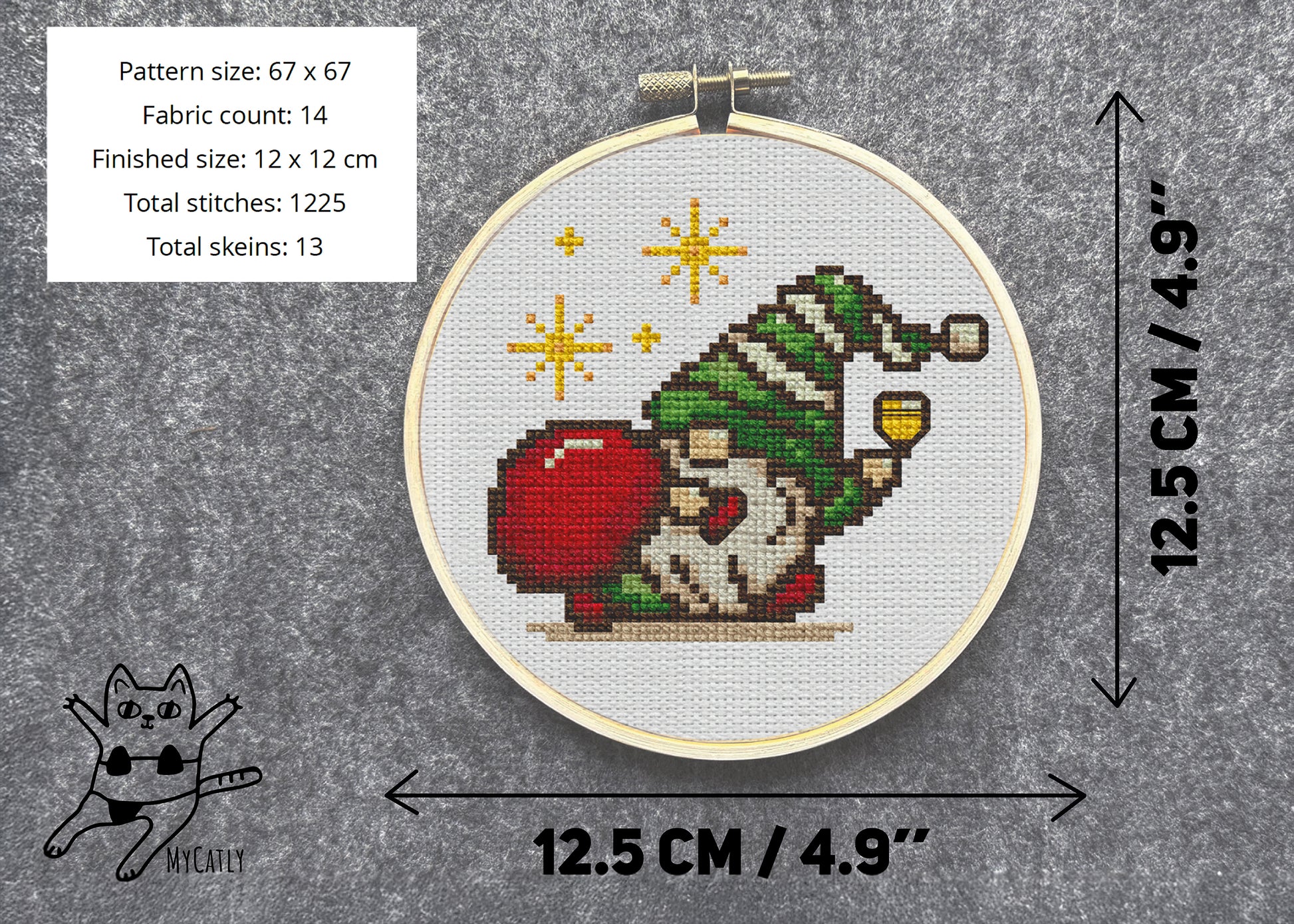 Cross-stitched gnome pattern in a hoop with dimensions and fabric details on a gray background.