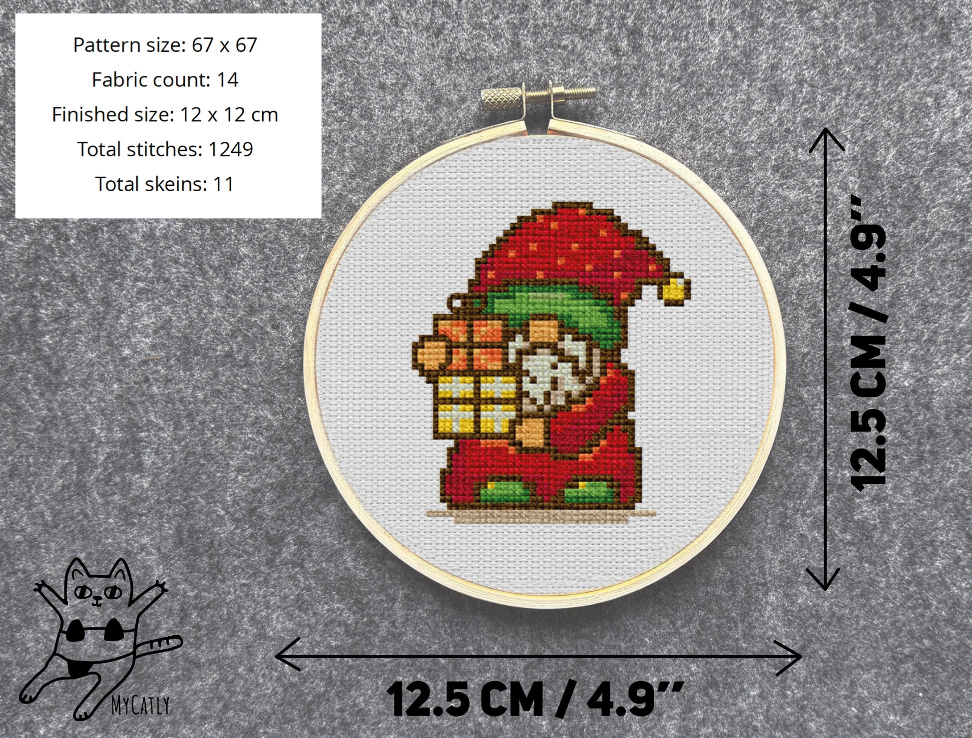 Cross-stitched gnome pattern in a hoop with dimensions and fabric count details on a gray background.