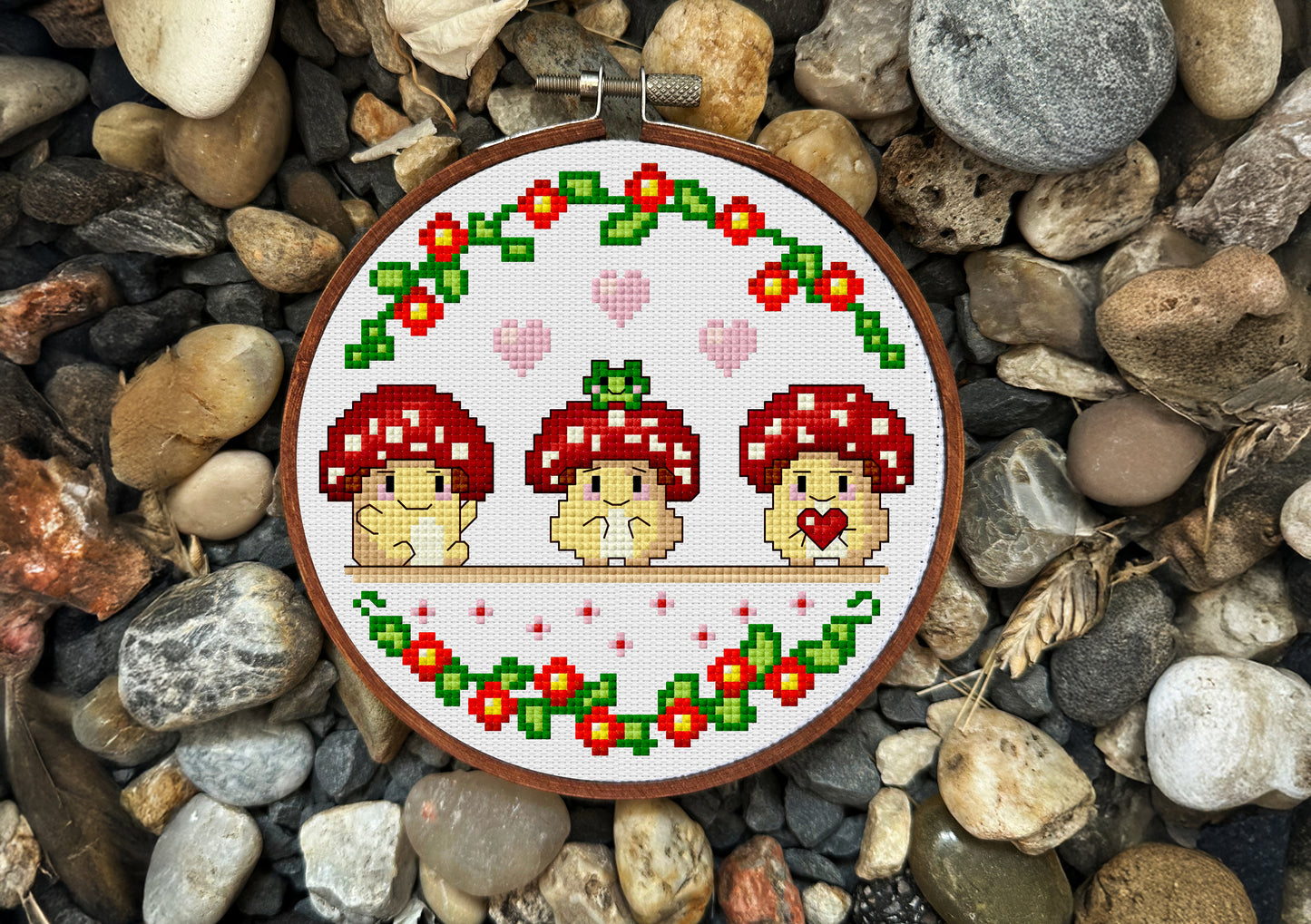 Cross-stitch design of three kawaii mushrooms with flowers