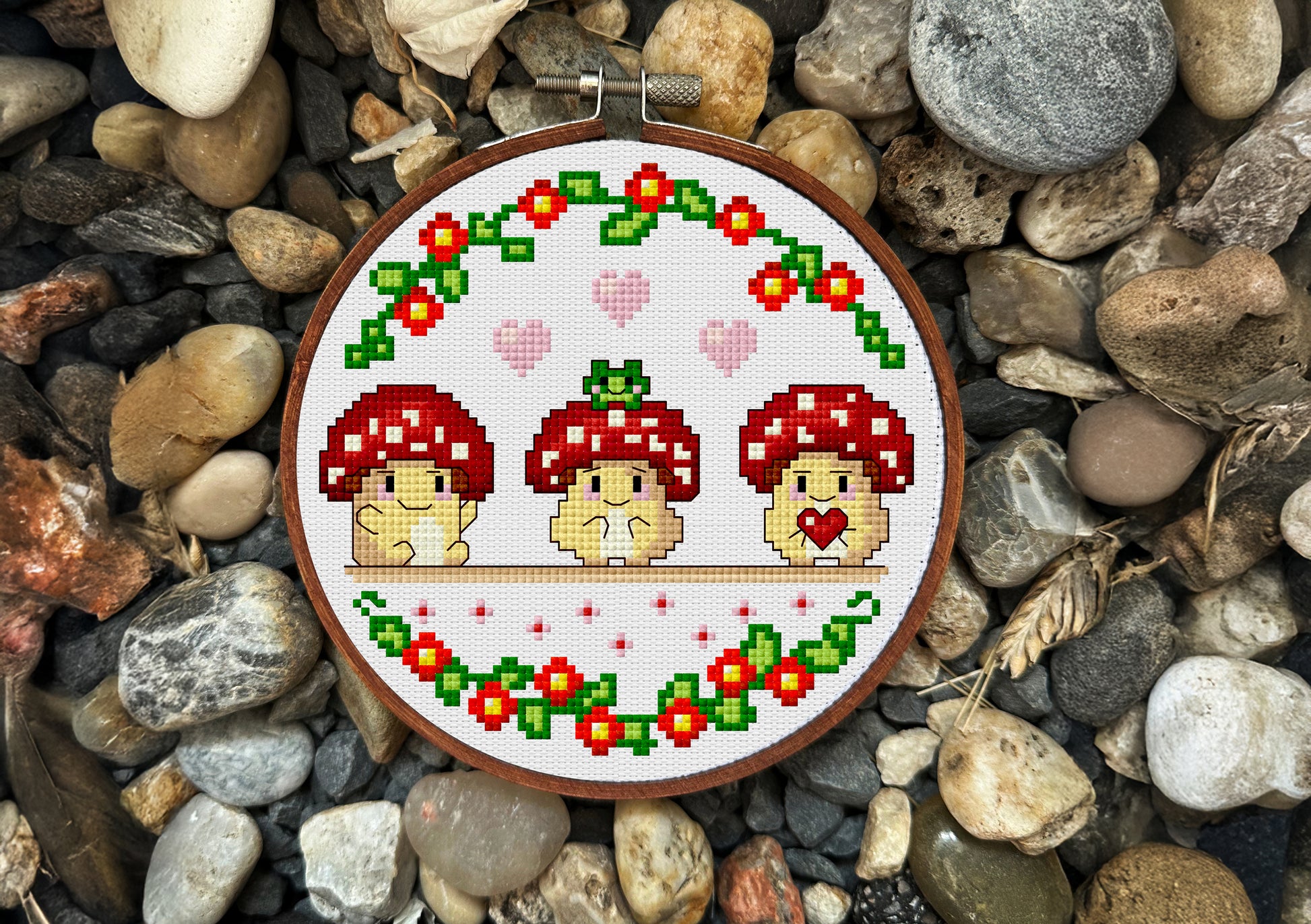 Cross-stitch design of three kawaii mushrooms with flowers