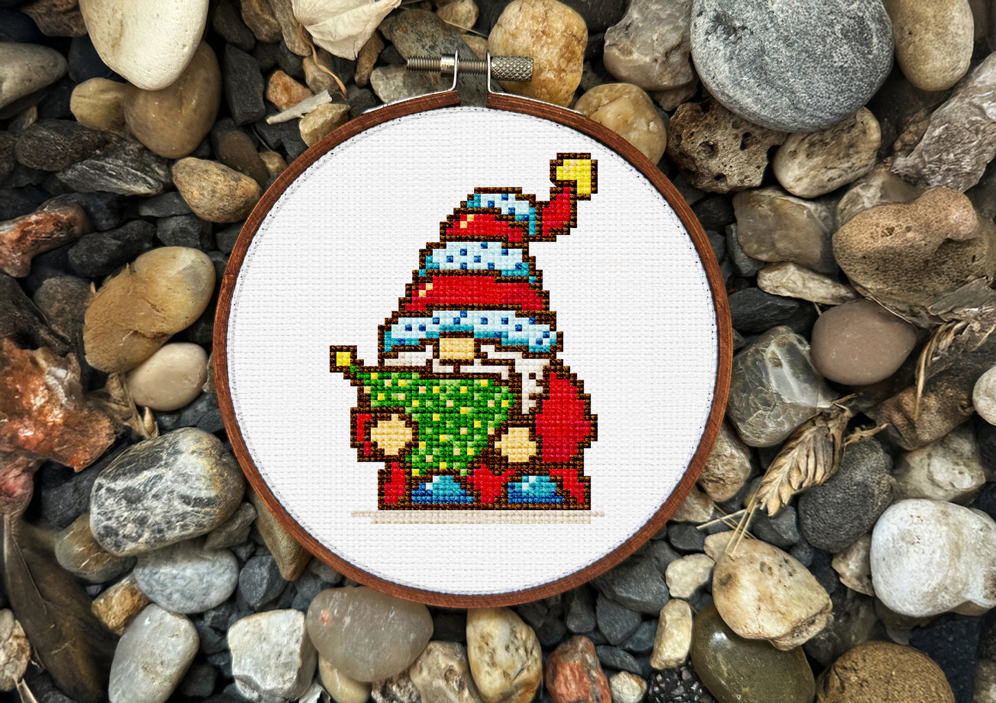 Pixel-art Christmas cross-stitch pattern with gnome and lights
